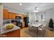 Eat-in kitchen featuring wooden cabinetry, black appliances and a ceiling fan at 19602 N Canyon Whisper Dr, Surprise, AZ 85387