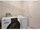 Convenient laundry room features a modern washer and dryer with overhead wire shelving at 19602 N Canyon Whisper Dr, Surprise, AZ 85387