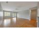 Bright and open living room with wood floors, ceiling fans and a doorway leading to another room at 19602 N Canyon Whisper Dr, Surprise, AZ 85387