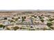 Panoramic aerial shot showcasing a neighborhood with diverse homes, desert landscapes, and easy access to a nearby highway at 2102 E Norwood St, Mesa, AZ 85213