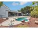 View of a pool with diving board and rock features set in a beautifully landscaped backyard at 2102 E Norwood St, Mesa, AZ 85213