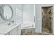 Well-lit bathroom featuring tub with glass block window and a separate shower at 2102 E Norwood St, Mesa, AZ 85213