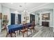 Formal dining room with chandelier lighting, rich wood furnishings, and an inviting atmosphere at 2102 E Norwood St, Mesa, AZ 85213