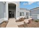 Elegant covered entryway with double doors, stylish wreath decor, and meticulously maintained xeriscaping at 2102 E Norwood St, Mesa, AZ 85213