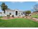 Charming single-story home with a well-manicured lawn, desert landscaping and a tiled roof at 2102 E Norwood St, Mesa, AZ 85213