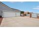 Spacious driveway and two-car garage with access to a gated side yard at 2102 E Norwood St, Mesa, AZ 85213