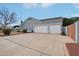 Large driveway with a two car garage, light grey walls, and tile roof at 2102 E Norwood St, Mesa, AZ 85213