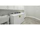 Functional laundry room with cabinetry and sink for added convenience at 2102 E Norwood St, Mesa, AZ 85213