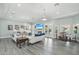 Inviting living area with cozy sofas, a fireplace, and seamless transitions to dining and outdoor spaces at 2102 E Norwood St, Mesa, AZ 85213