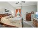 Bright main bedroom with a carved wood bed frame, an area rug and a window with curtains at 2102 E Norwood St, Mesa, AZ 85213