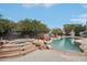 Backyard view of the pool area, surrounded by mature landscaping, perfect for outdoor relaxation at 2102 E Norwood St, Mesa, AZ 85213