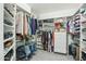 Organized walk-in closet with shelves and hanging racks for clothing and accessories at 2102 E Norwood St, Mesa, AZ 85213