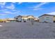 Wide shot of the rear of the house and detached structure showing a large gravel backyard and pool at 21036 E Stacey Rd, Queen Creek, AZ 85142