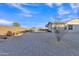 Expansive gravel backyard with minimal landscaping, offering a spacious outdoor area and partial view of the house at 21036 E Stacey Rd, Queen Creek, AZ 85142