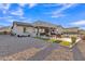 Expansive backyard featuring a covered patio, outdoor kitchen, artificial turf, and a gravel area at 21036 E Stacey Rd, Queen Creek, AZ 85142