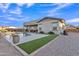 Expansive backyard featuring gravel landscaping, a patio area, an inviting pool and well-manicured artificial turf at 21036 E Stacey Rd, Queen Creek, AZ 85142