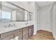 Modern bathroom featuring double sinks, wood cabinets, tile floor, shower and separate water closet at 21036 E Stacey Rd, Queen Creek, AZ 85142