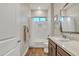 Charming bathroom features a shower-tub combo, stylish vanity and warm wood-look tile flooring at 21036 E Stacey Rd, Queen Creek, AZ 85142