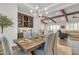 Elegant dining room featuring a bar area, modern chandelier, and seamless flow into the living space at 21036 E Stacey Rd, Queen Creek, AZ 85142