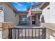 Charming home featuring a quaint front porch seating area, enhanced by an American flag and stylish stone accents at 21036 E Stacey Rd, Queen Creek, AZ 85142