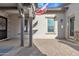 Charming front porch with an American flag, stone pillars, a cozy seating area, and a stylish front door at 21036 E Stacey Rd, Queen Creek, AZ 85142