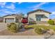 Beautiful home featuring lush front yard landscaping and manicured gravel, complemented by a stylish stone exterior accent at 21036 E Stacey Rd, Queen Creek, AZ 85142