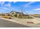 Beautiful home featuring lush front yard landscaping and manicured gravel, complemented by a stylish stone exterior accent at 21036 E Stacey Rd, Queen Creek, AZ 85142