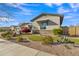 Charming home featuring lush front yard landscaping and manicured gravel, complemented by a stylish stone exterior accent at 21036 E Stacey Rd, Queen Creek, AZ 85142