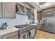 Modern kitchen featuring stainless steel appliances, custom cabinetry, and a stylish backsplash, ideal for culinary enthusiasts at 21036 E Stacey Rd, Queen Creek, AZ 85142