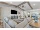 Bright living room with wood beams, a TV, and an entertainment center at 21036 E Stacey Rd, Queen Creek, AZ 85142