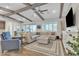 Cozy living room with wood beams, a large sectional, and natural light at 21036 E Stacey Rd, Queen Creek, AZ 85142