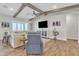 Comfortable living room with a blue armchair, a sectional, and wood-look flooring at 21036 E Stacey Rd, Queen Creek, AZ 85142