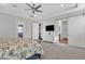 Spacious main bedroom featuring tray ceilings, ceiling fan, walkout balcony, and en suite bathroom with sliding barn door at 21036 E Stacey Rd, Queen Creek, AZ 85142