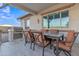 Covered outdoor patio with a built-in grill and a dining table with seating at 21036 E Stacey Rd, Queen Creek, AZ 85142