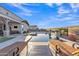 Inviting pool area with lounge chairs, waterfall feature, and lush landscaping, perfect for relaxation at 21036 E Stacey Rd, Queen Creek, AZ 85142