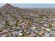 An aerial view of a neighborhood shows tree-lined streets, pools, and picturesque mountain views at 2212 E Hillery Dr, Phoenix, AZ 85022