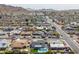 An aerial view showcases a neighborhood with a private pool surrounded by artificial grass landscaping at 2212 E Hillery Dr, Phoenix, AZ 85022