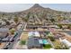 Wide aerial view of the neighborhood with homes, mountains in the distance, and blue skies at 2212 E Hillery Dr, Phoenix, AZ 85022