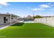 Large backyard with artificial turf, an inground pool, and mountain views at 2212 E Hillery Dr, Phoenix, AZ 85022