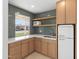 Well designed bar area featuring custom cabinets, open shelving, and quartz countertop at 2212 E Hillery Dr, Phoenix, AZ 85022