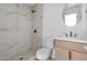 Bright bathroom featuring a tiled walk-in shower and modern vanity at 2212 E Hillery Dr, Phoenix, AZ 85022