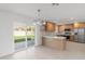 Modern kitchen featuring stainless steel appliances, a stylish backsplash, and sliding door access to the backyard at 2212 E Hillery Dr, Phoenix, AZ 85022