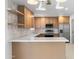 Modern kitchen featuring custom cabinets, stylish lighting, and stainless steel appliances at 2212 E Hillery Dr, Phoenix, AZ 85022