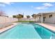 Backyard featuring a sparkling pool, covered patio, and manicured artificial lawn at 2212 E Hillery Dr, Phoenix, AZ 85022