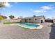 An inground pool is surrounded by gravel in this private backyard at 2212 E Hillery Dr, Phoenix, AZ 85022