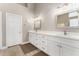 Bathroom with dual sinks, quartz countertops, and modern lighting fixtures at 2348 W Flint St, Chandler, AZ 85224