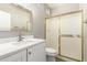 Updated bathroom featuring vanity with solid countertop and gold trimmed glass shower at 2348 W Flint St, Chandler, AZ 85224