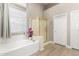 Bathroom featuring a bathtub, glass shower, and modern fixtures at 2348 W Flint St, Chandler, AZ 85224