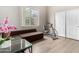 Bedroom with neutral walls, wood floor, a large window and closet with a brown couch at 2348 W Flint St, Chandler, AZ 85224