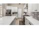 Bright kitchen boasts white cabinets, quartz countertops and stainless appliances at 2348 W Flint St, Chandler, AZ 85224